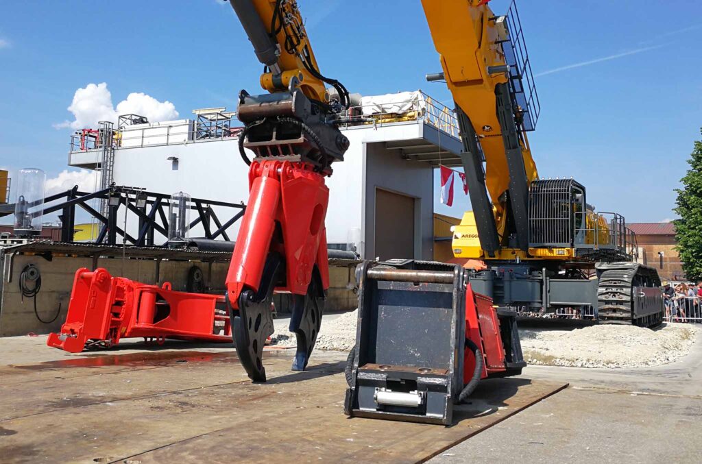 Leistungsstarker hydraulischer Schnellwechsler und Anbaugeräte von MR Riedlberger im Einsatz an einem Großbagger auf der Baustelle.